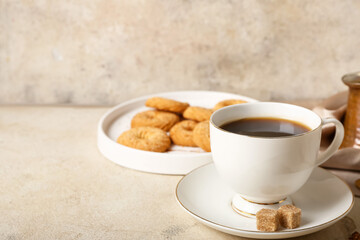 Cup of hot coffee on light background