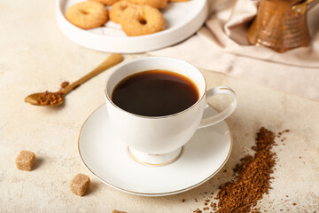 Cup of hot coffee on light background
