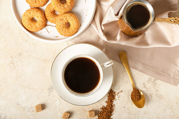Cup of hot coffee on light background