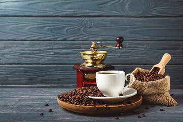 Composition with cup of hot coffee on dark wooden background