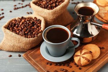 Composition with cup of hot coffee on dark wooden background