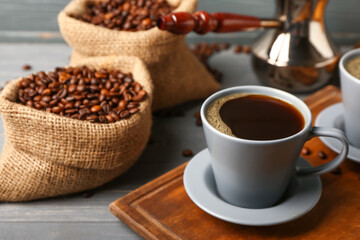 Composition with cup of hot coffee on dark wooden background