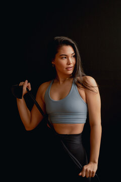 Strong Athletic Woman In Front Of Black Wall