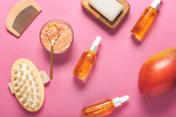 Composition with mango essential oil and bath supplies on color background