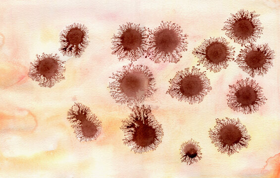 Brown ink dots on peachy background