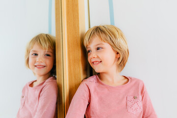 Cute girl looking at mirror