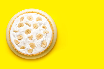 Plate with tasty banana pie on color background