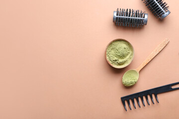Bowl with henna and hairdresser's supplies on color background