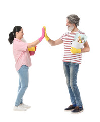 Mature couple with cleaning supplies giving each other high-five on white background