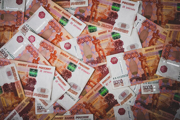 Rubles background. Russian money banknotes of five thousand rubles, scattered all over the surface.