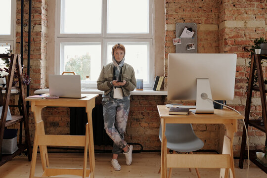 Hipster girl in coworking space with high tables