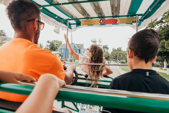Family riding around St. Joe Michigan in a surrey bike.