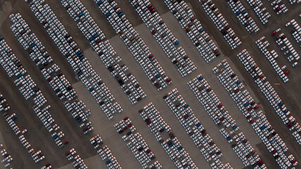Large car parking in front of a car factory - grid filled with cars