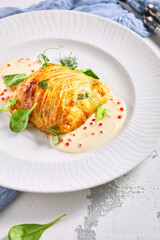 Zander Fish Baked in Dough with Caviar and Cream Sauce. Restaurant food plate on white table. Delicious baked fish meal.