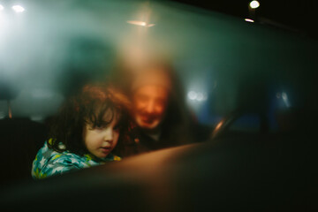 Kid and father inside a car with steamy windows