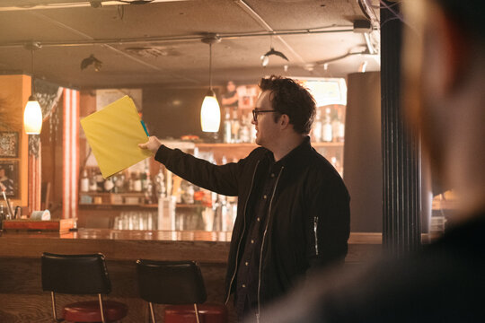 A film director holds up a binder
