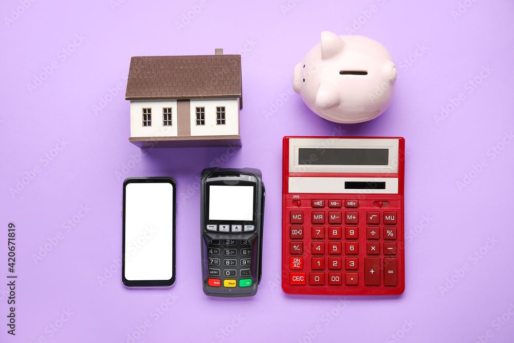 Sticker calculator with model of house, payment terminal, mobile phone and piggy bank on color background