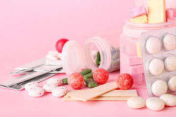 Tasty chewing gums on color background