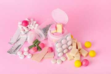 Tasty chewing gums on color background