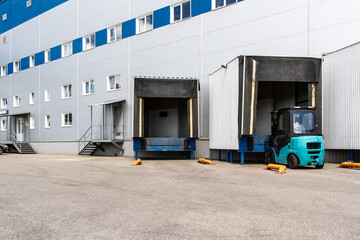 General view to the loading gates in the big distribution warehouse with forklift