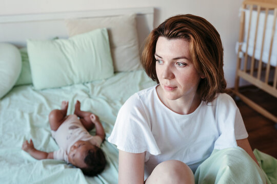 Young mother with her newborn baby.