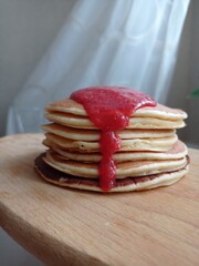 a stack of delicious pancakes with strawberry jam