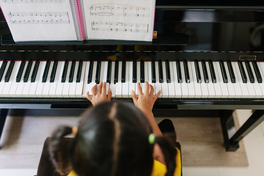 View from above of a girl playing the piano