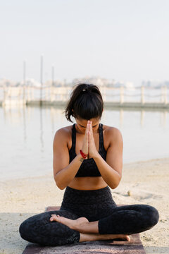A woman in a resting yoga pose
