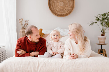Happy family on bed at home
