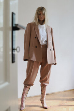 Artistic and fashion photo of a blonde girl with nice clothes in room.