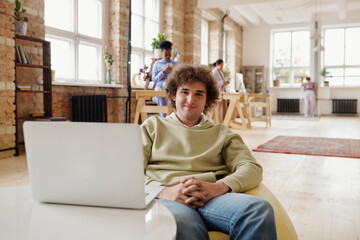 Smiling guy in coworking space