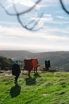 Group of mountaineers hiking on green hill