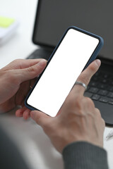 Close up view of man holding mock up smart phone with white screen.