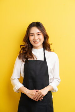 Beautiful housewife with gesture isolated on yellow background
