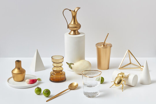 Modern set from golden cutlery and different things.