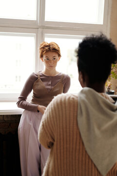 Redhead woman listening to colleague