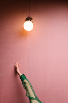 woman with green outfit in a pink room