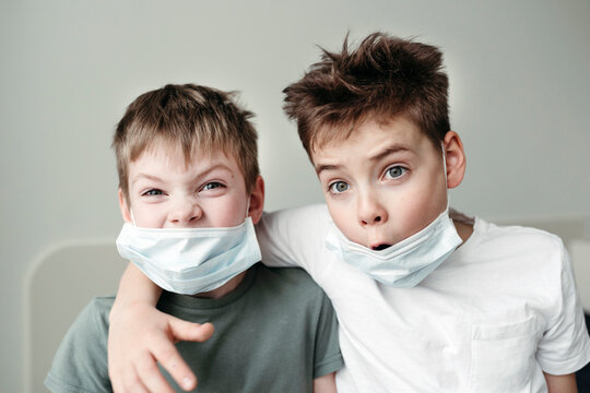 Young brothers in protective medical masks.