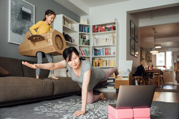 Pregnant woman doing yoga at home