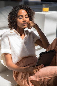 Woman reading a book from a digital tablet