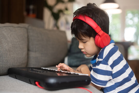 Little Kid Playing Keyboard At Home