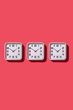 three clocks on a red background