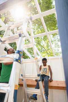 Father and son in playhouse under construction