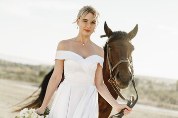 Portrait of a beautiful bride with horse