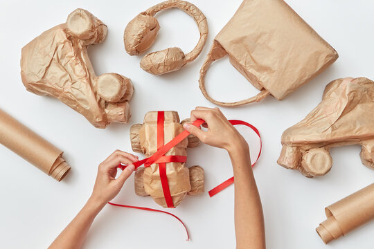 Woman's hands making craft gift wrap for things.