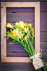 bouquet of yellow flowers on wooden background. mother's day. copy-space. selective focus