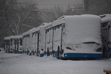 Almaty, Kazakhstan - 01.28.2014 : Urban public transport stands in a row on the territory of the car park in snowy weather