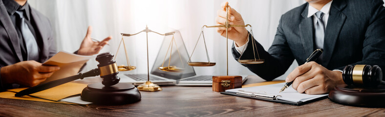justice and law concept.Male judge in a courtroom on wooden table and Counselor or Male lawyer...