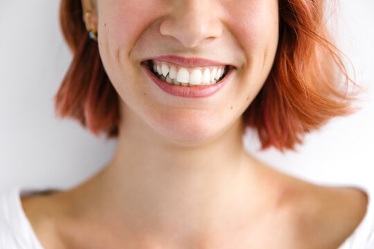 Beautiful young woman smiling - Powered by Adobe