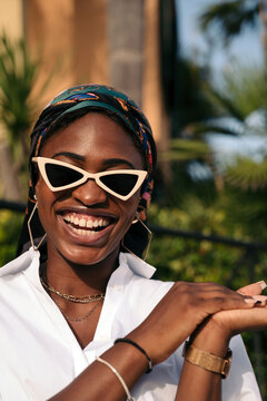 Black woman with sunglasses laughing